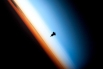 11. Силуэт шаттла Индевор на фоне Земли. Сфотографирован членами 22-й экспедиции на МКС. Оранжевый цвет — тропосфера, беловатый цвет — стратосфера (высота 8–16 км до 45–55 км), который переходит мезосферу (высота от 50–55 до 80 км). (Фото НАСА)