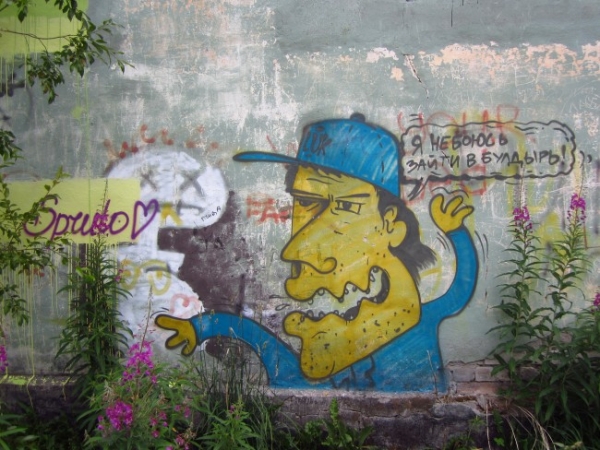 А этот потертый персонаж с незамысловатым посланием красуется на стене заброшенного Дома Культуры в Катунино. 