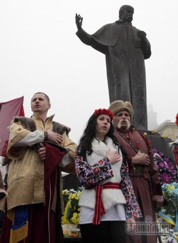 Участники празднования Дня гимна поют гимн Украины возле памятника Тарасу Шевченко во Львове