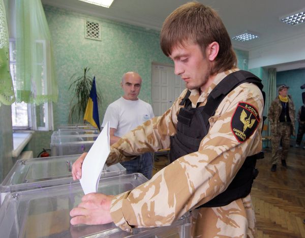 Участник самообороны Майдана голосует на внеочередных выборах президента Украины на одном из киевских избирательных участков.