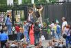 Митингующие пытаются повесить траурные венки на забор генконсульства
