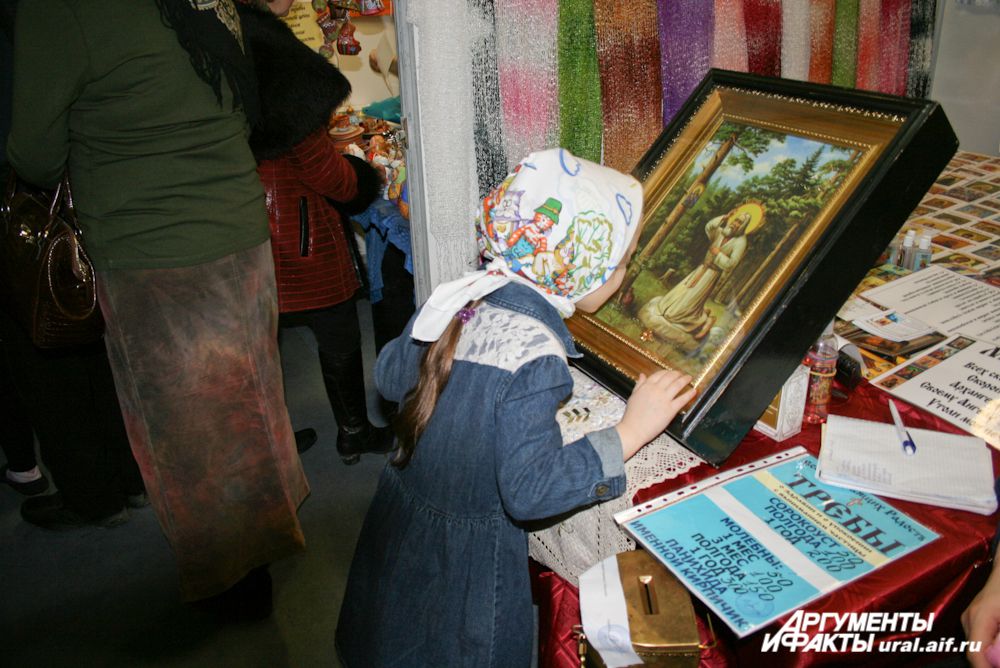 К святыням на выставке прикладываются и взрослые и дети.