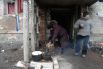 Жители Дебальцево готовят еду на костре у подъезда жилого многоквартирного дома, пострадавшего в результате обстрелов во время боевых действий.