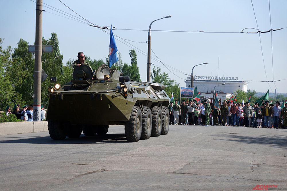 Порядка пяти тысяч участников, одетые в военную форму и вооружившись флагами, прошлись большой колонной от здания Речного вокзала до памятника Уральскому добровольческому танковому корпусу.