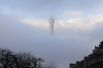 Эйфелева башня в это утро была окутана туманом.
