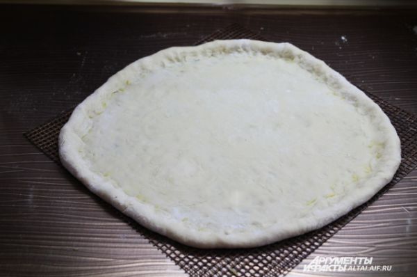 Делаем сырный бортик, аккуратно защипывая края пиццы вовнутрь.