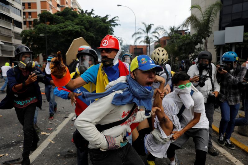 Пострадавший в результате столкновения с ОМОН во время митинга против президента Николаса Мадуро в Каракасе.