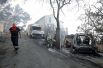 Пожарный идёт мимо сгоревших автомобилей в Карро, Франция.