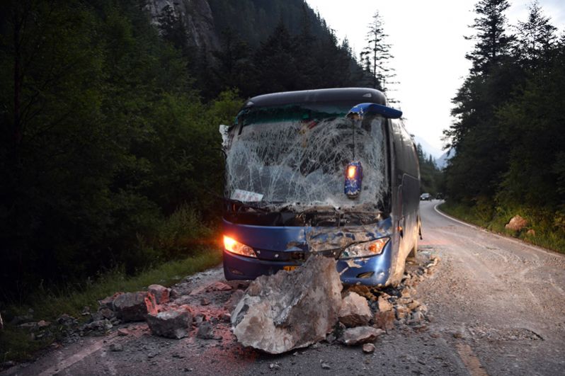 Автобус, пострадавший от упавших камней на шоссе S301 в уезде Цзючжайгоу провинции Сычуань на юго-западе Китая.