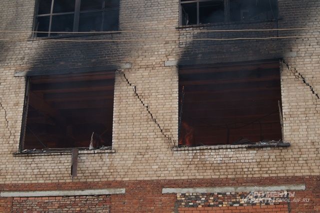 На стенах здания очень хорошо просматриваются трещины, появившиеся во время пожара.