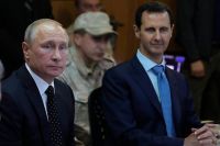 Владимир Путин и Башар Асад во время посещения авиабазы Хмеймим в Сирии.