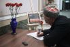 Мужчина оставляет запись в книге соболезнований в Санкт-Петербургском Доме национальностей в связи с происшествием в Керченском политехническом колледже.