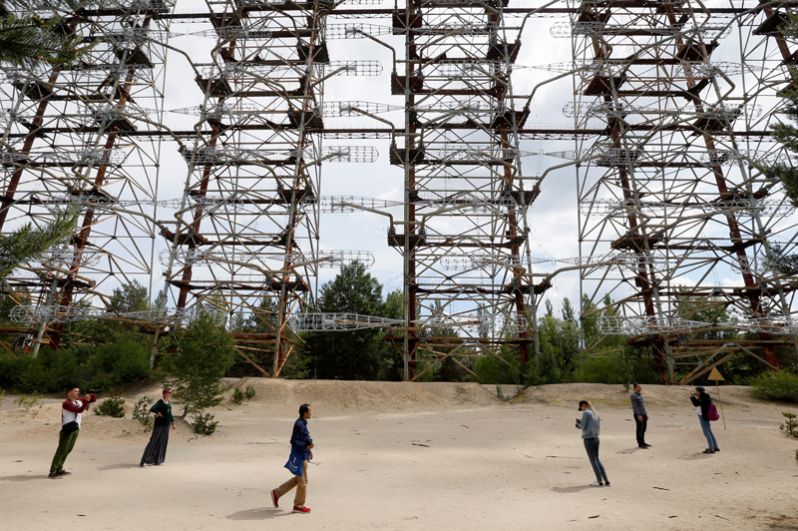 Туристы фотографируются у загоризонтной радиолокационной станции «Дуга», остановленной в связи с аварией.