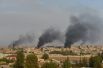 Дым на территории сирийского пограничного города Рас-эль-Айн, вид со стороны турецкого города Джейланпынар.