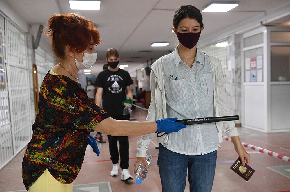 Сотрудница службы безопасности досматривает ученицу на наличие запрещенных на экзамене предметов перед началом единого государственного экзамена по информатике в образовательном центре гимназии No 6 «Горностай» в Новосибирске.