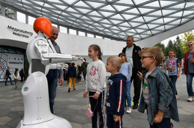 Посетители парка «Зарядье» возле интерактивного мобильного робота-промоутера Kiki.