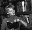 Ирина Скобцева у домашней библиотеки, 1958 год.