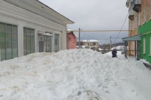 Из-за оттепели с крыш начал сходить снег.
