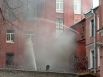 Пожарные тушат здание фабрики
