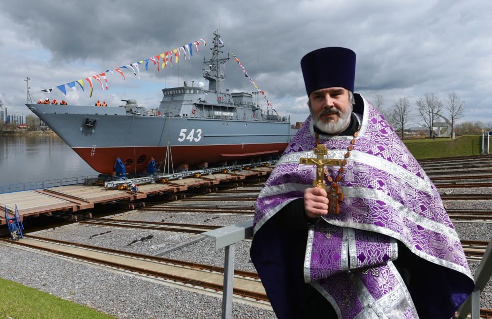 Священнослужитель во время торжественной церемонии спуска на воду тральщика "Петр Ильичев"