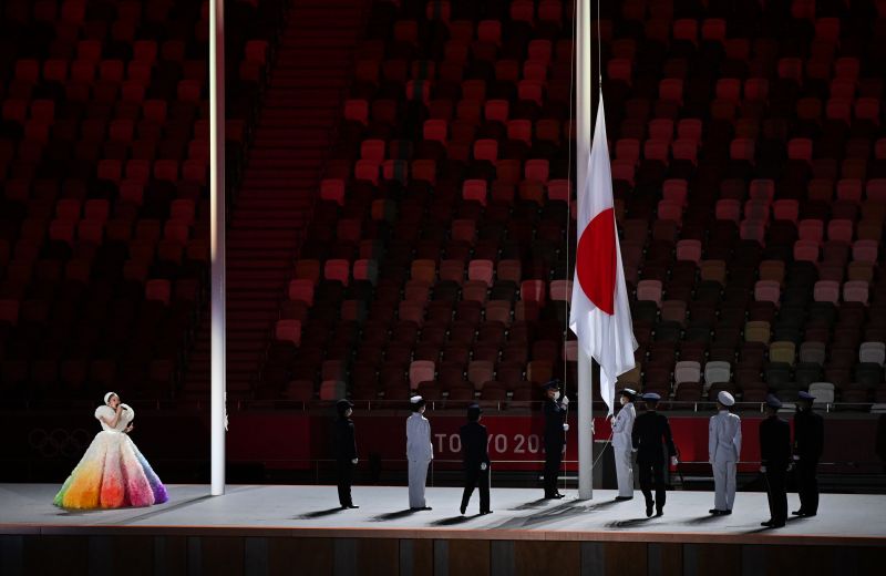 Певица MISIA (слева) выступает во время поднятия флага Японии на церемонии открытия на Национальном олимпийском стадионе