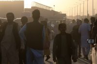 Люди возле пункта эвакуации возле международного аэропорта имени Хамида Карзая в Кабуле.