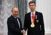 Президент РФ Владимир Путин и двукратный чемпион XVI Паралимпийских летних игр по плаванию спорта лиц с поражением опорно-двигательного аппарата в дисциплине 100 м на спине в классе S9 и в комбинированной мужской эстафете 4x100 м (справа) Богдан Мозговой на церемонии вручения государственных наград РФ победителям XVI Паралимпийских летних игр 2020 года в Токио