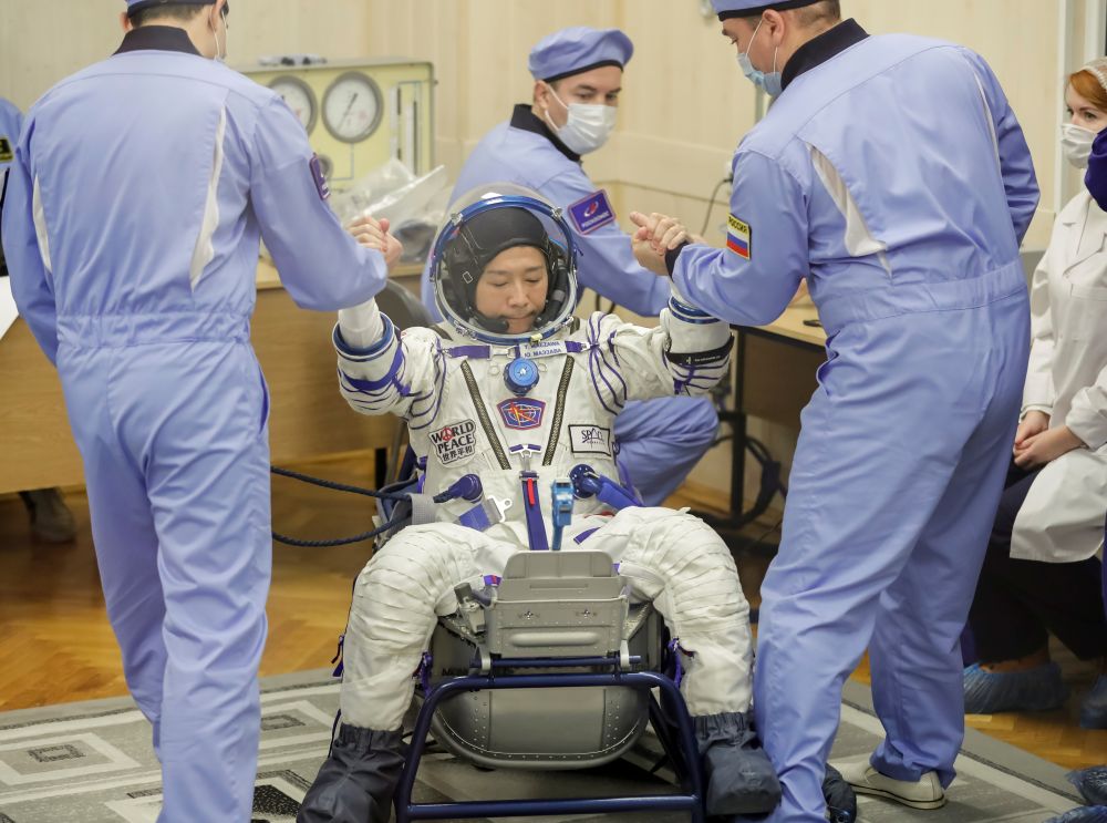 Член основного экипажа 20-й экспедиции на МКС японский космический турист Юсаку Маэдзава после облачения в скафандр в монтажно-испытательном корпусе космодрома Байконур