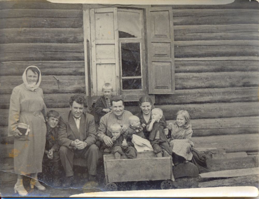 ФОТО №21. 1957 г. Мы жили г. Усолье-Сибирское на ул. Комсомольская, 2.  Сейчас на этом месте стоят многоэтажки. На фото мои папа, мама, братья, сестра, дядя и его жена, а также наше самодельная тележка для катания маленьких братьев. 