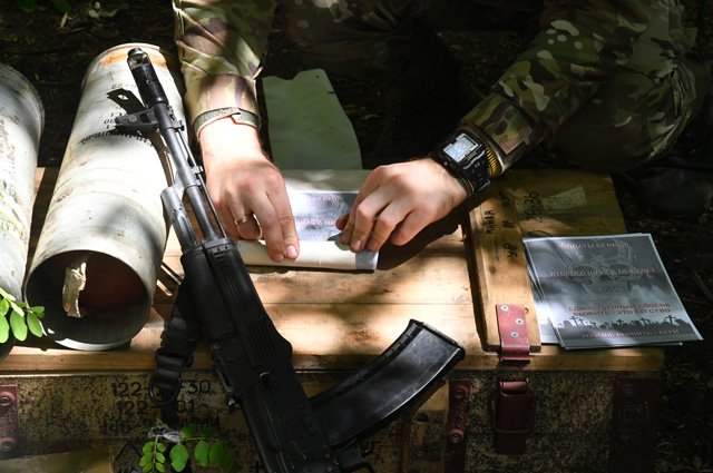 Военнослужащий РФ заряжает листовками агитационный снаряд.