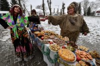 Жители белорусской деревни Семежево дегустируют напитки и блюда национальной кухни во время празднования Старого Нового года.