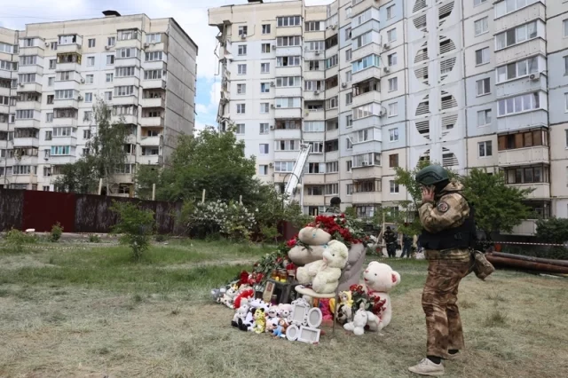 Стихийный мемориал у поврежденного ракетой украинских нацистов ВСУ жилого дома в Белгороде. 