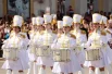 Девушки в красивой белоснежной форме прошли по главной площади города.