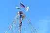 Главный приз - петух, заключенный в клетку на самой вершине столба.