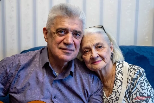 Николай Иванович и Галина Валентиновна. Она всё так же смотрит на него с нежностью, а он помогает в домашних делах и играет ей романтичные песни под гитару.