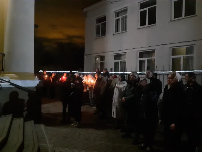 Люди зажигают свечи в ожидании праздника.