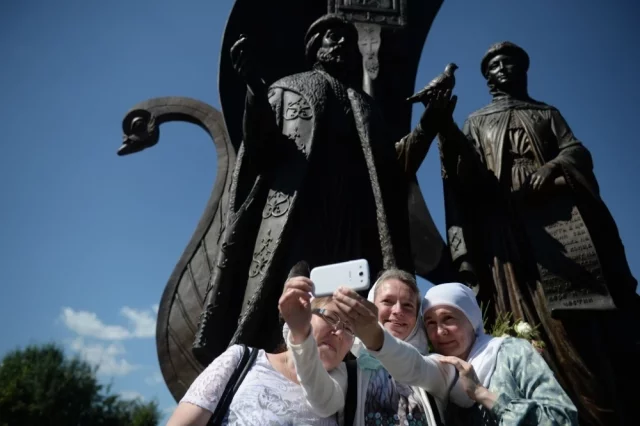 Верующие после крестного хода у памятника Петру и Февронии Муромских в Екатеринбурге.